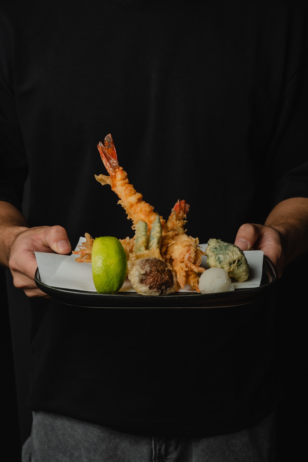A plate of prawn tempura held up to the camera